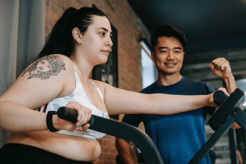 a women working out on an assault bike
